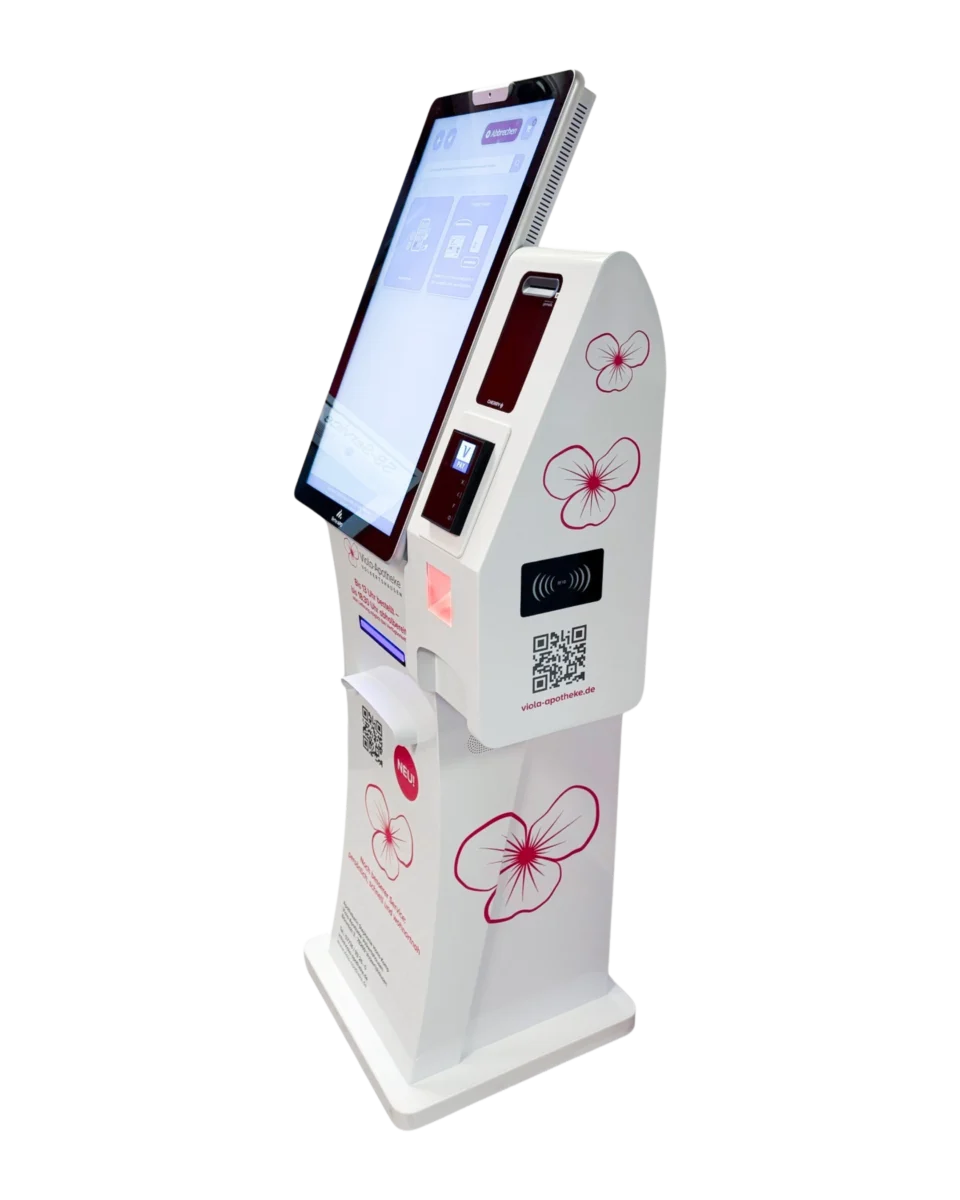 Weißes Apotheken-Terminal der Viola-Apotheke Volkertshausen mit Touchscreen, Kartenleser für die Gesundheitskarte, Bezahlterminal und QR-Code, verziert mit pinken Viola-Blüten